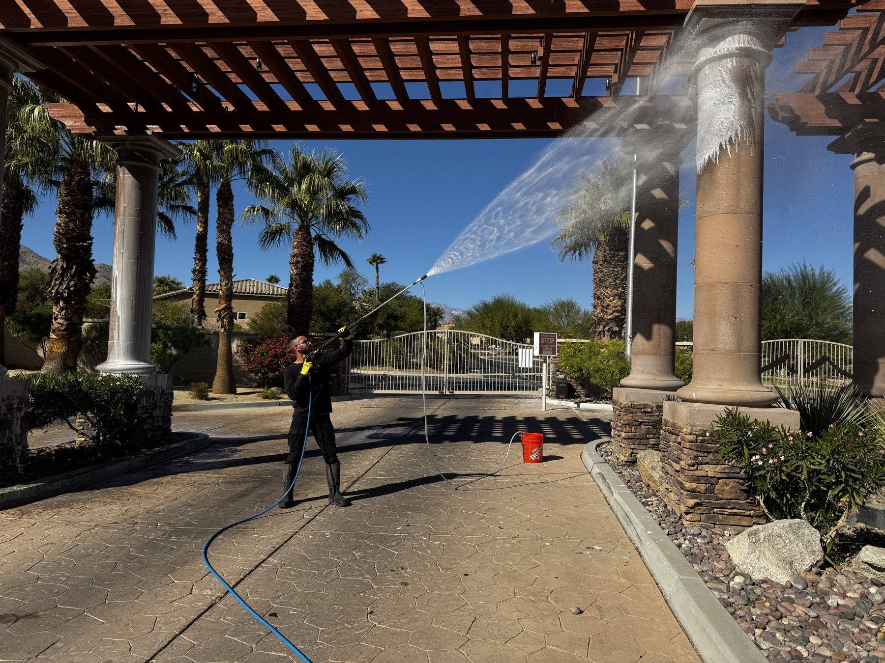 A resort colonnade and paving being washed